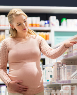 Pregnant finding medicine in a pharmacy store